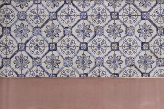 Blue traditional Portuguese ceramic tiles pattern, azulejos. Beautiful shabby dirty pink facade, wall banner. Old Lisbon building decoration Portugal decorative background with geometric stars ornaments.
