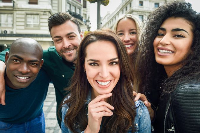 Happy group of friends posing for selfie