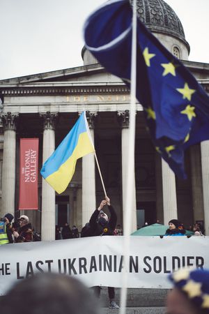 London, England, United Kingdom - March 5 2022: Man waving Ukrainian flag at protest