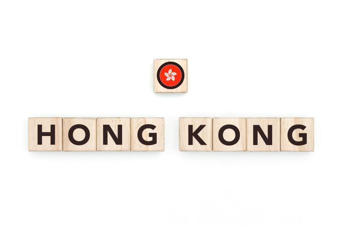 Wooden blocks bearing the name and flag of Hong Kong. HongKonger and Asian Culture, national identity, travel, and geography in a copy space design.