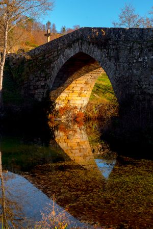 Old bridge over calm river