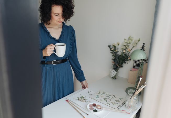 Painter with cup of coffee at work