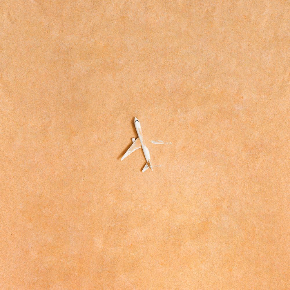 Airplane partially submerged in sand