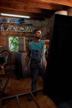 Worker standing in light workshop