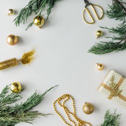 Christmas layout made of present, branches, baubles on light background
