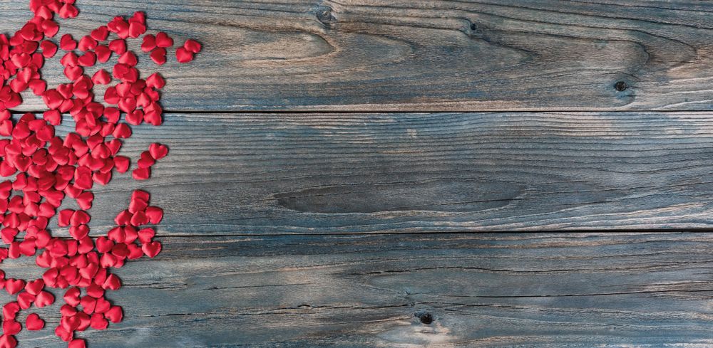 Valentine’s day with little red hearts on blue wood