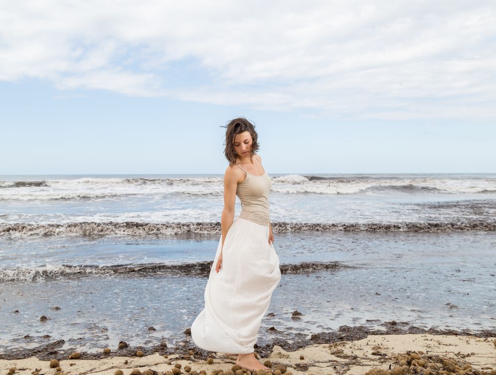 Charming young woman on shore near water