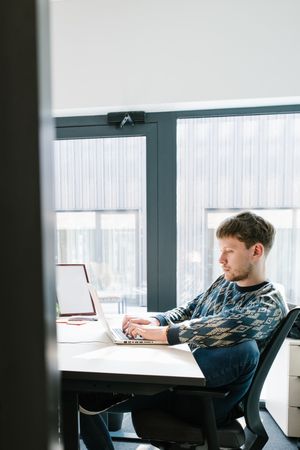 Man working on laptop in office