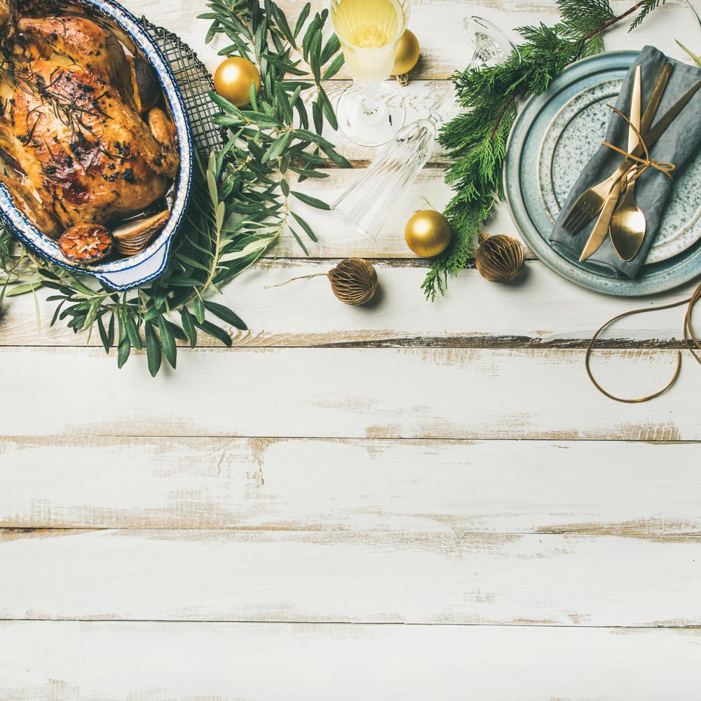 Roast chicken, table setting, decorations of fir, on a light background, square crop, copy space