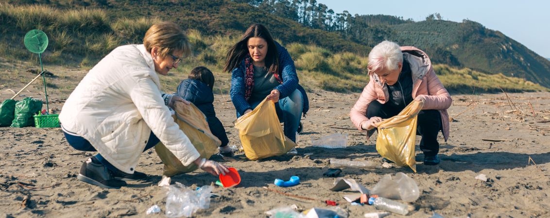 Female volunteers cleaning the beach