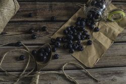 Tasty bilberry on wooden surface