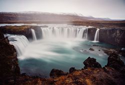 Waterfall between lands of valley