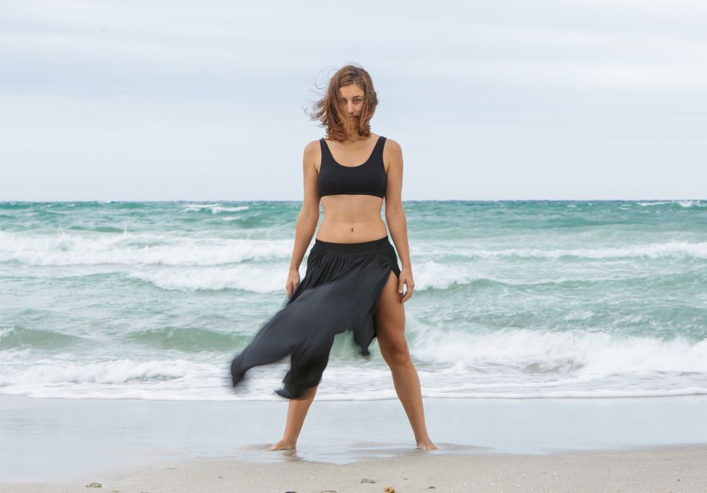 woman dancing near sea