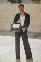 Stylish Black woman with handbag and sunglasses on street