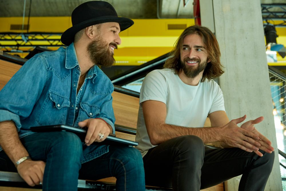 Men sitting on stairs and lively chatting