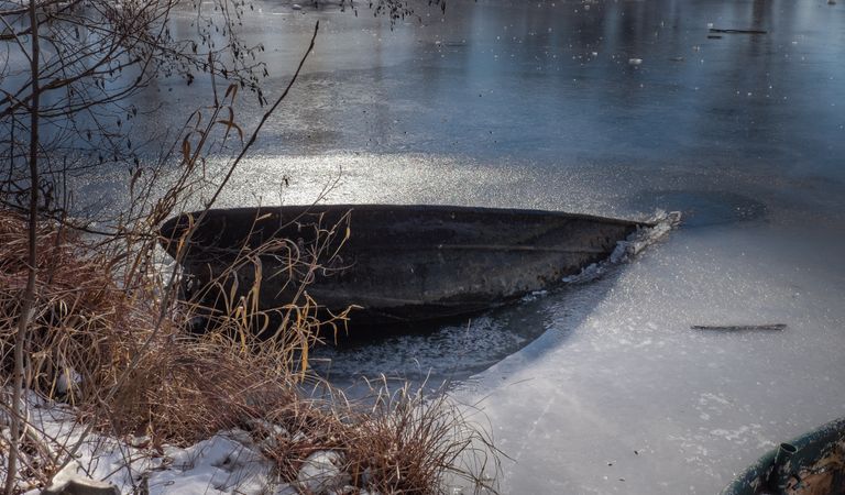 Drowning boat frozen in lake
