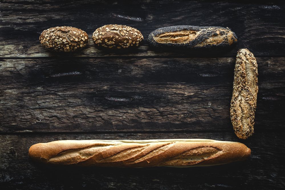 Assorted gold homemade bread on dark wood background