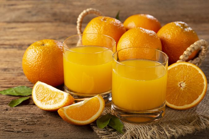 Glass with orange juice on the table.