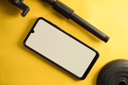 Mock up phone and accessory stand on yellow table