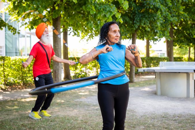 Mature Sikh people exercising in park