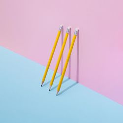 School pencils leaning on pastel background