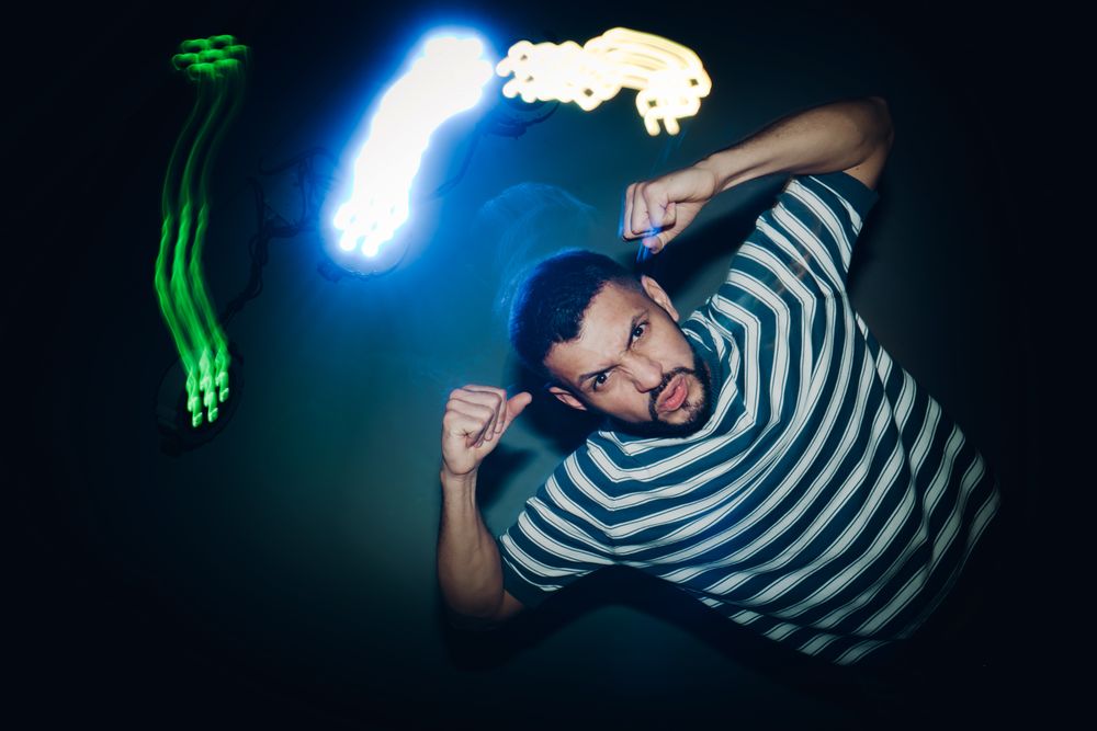 bearded man dancing in spotlight