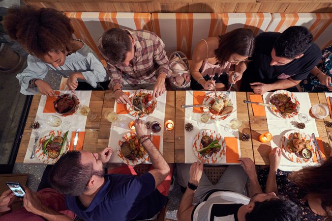 Group of diverse friends having dinner