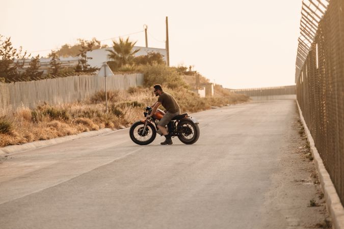 Strong man driving motorcycle