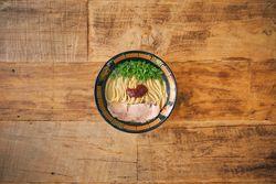 Tasty ramen with chopped green onions and tomato salsa