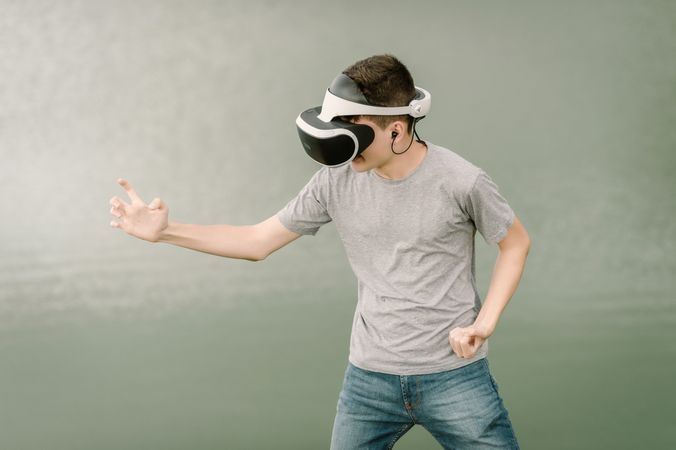Young teenager with virtual reality glasses outdoors