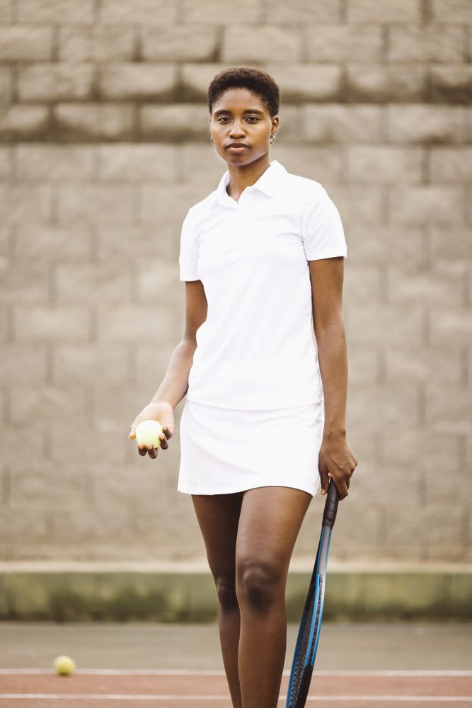 Young women with a racket in a tennis court