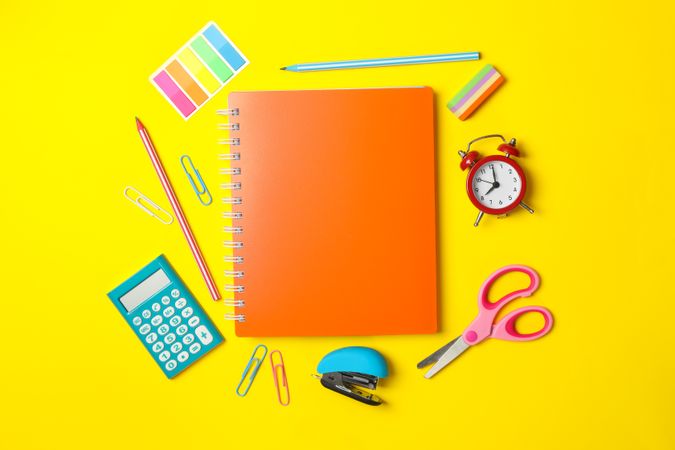 School supplies on yellow background, space for text