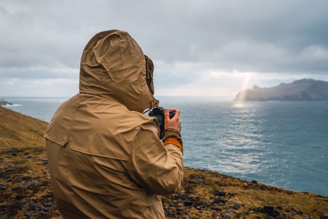 Back view of man photographing outdoors