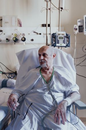 Older man admitted to a hospital room.