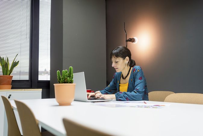 Smiling businesswoman working with laptop