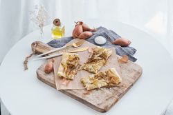Served onion tart on cutting board