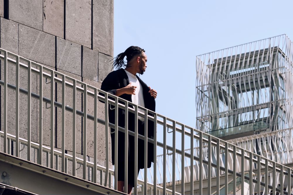 Black male standing on bridge