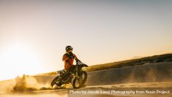 Rider riding dirt bike in the sand 5qnZK4