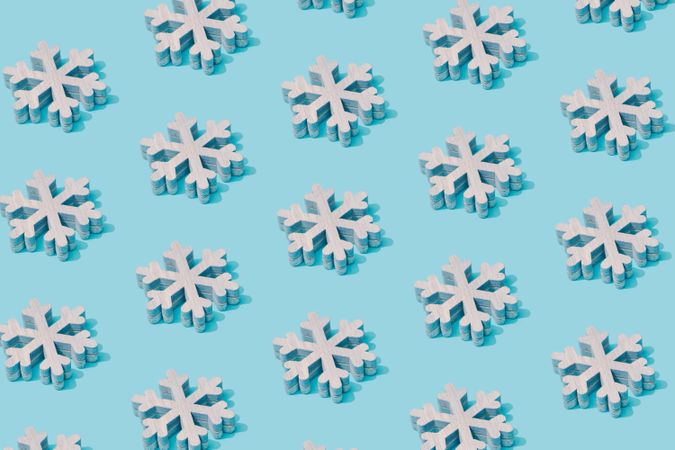 Pattern composition of light  snowflakes on pastel blue background