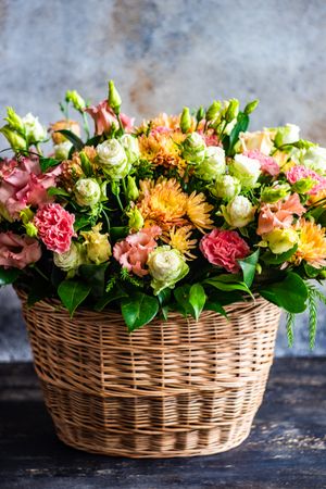 Floral composition with seasonal flowers in basket