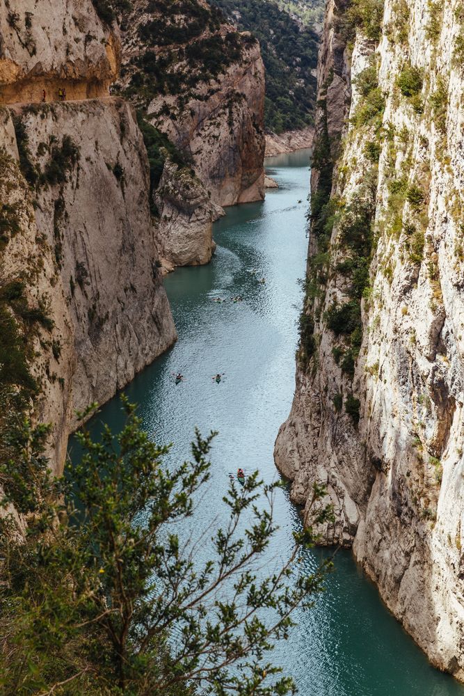 People crossing a river by kayak