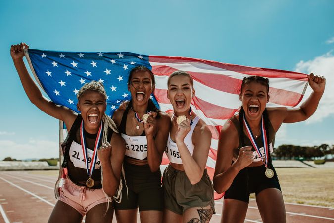 Group of female runner with medals winning a competition