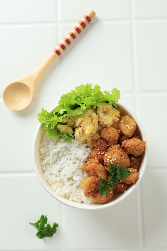 Top View Takeaway Rice Bowl with Chicken Popcorn and Scrambled Egg