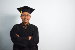 Proud male graduate in studio shoot