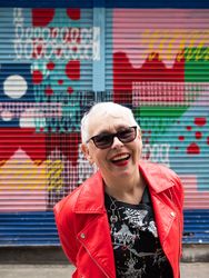 Laughing older woman in red leather jacket