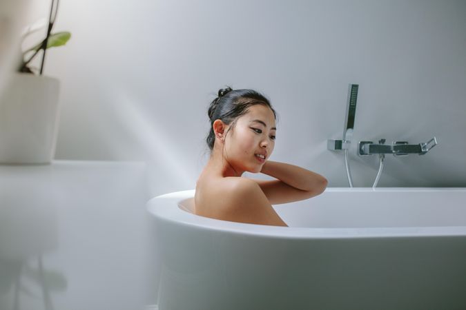 Young woman in bathtub