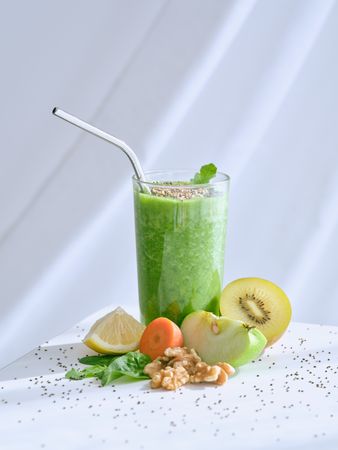Smoothie near assorted fruits in studio