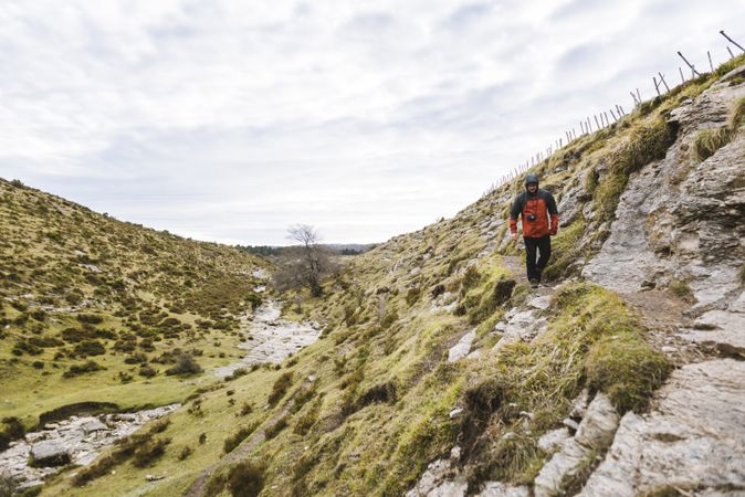 Man walking on hill near valley