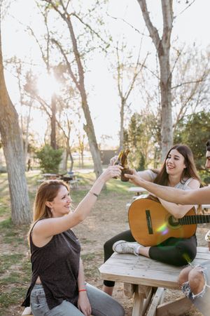 Young musicians drinking beer in park