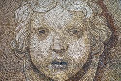 Ancient mosaic in warm hues at aged temple